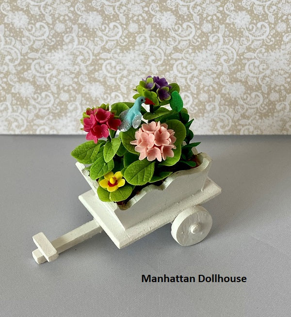Miniature Flowers and Blue Bird in a White Wheelbarrow