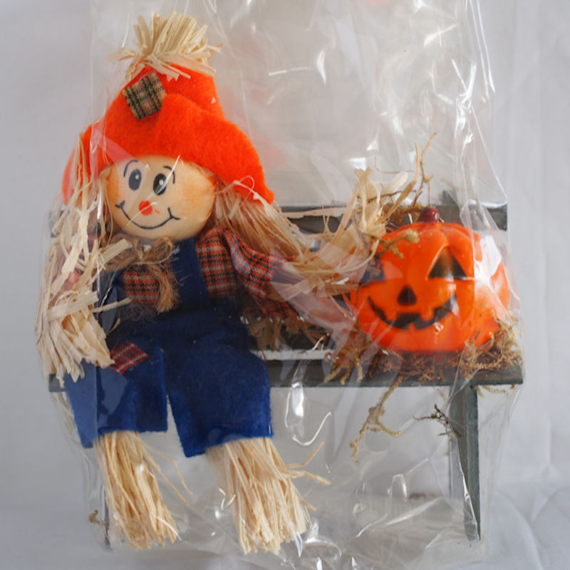 Miniature Scarecrow and Pumpkin on Park Bench