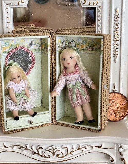 Two Pretty miniature dolls in their own wicker carrying case